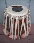 A tabla dayan with a torn head.