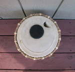Large hole in the pudi of a tabla dayan.