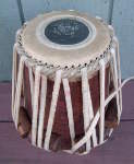 A tabla dayan with a damaged pudi.