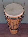 A torn goat skin drum head.
