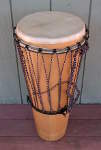 An ashiko hand drum with a broken drum head.