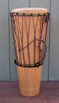 An ashiko hand drum with a skin that has torn.