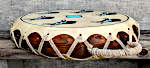 A repaired shell and new lacing on a two headed Native American frame drum.