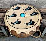 An octagonal two headed drum with torn lacing.