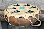 A two headed, octagonal frame drum with broken lacing.