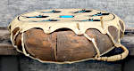A damaged shell and lacing on a two headed Native American frame drum.